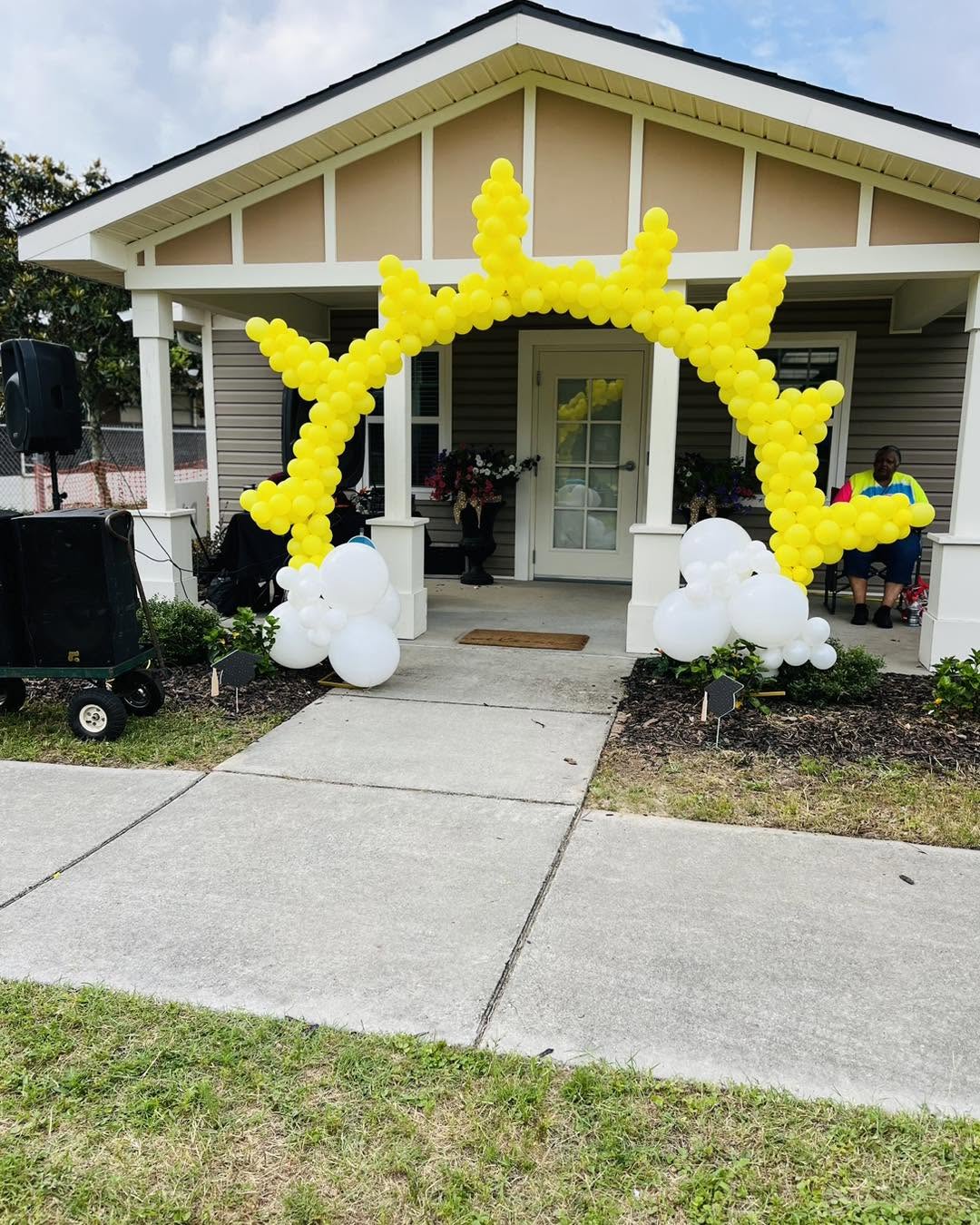 Balloon décor — Yellow and white crown balloon arch for a community event