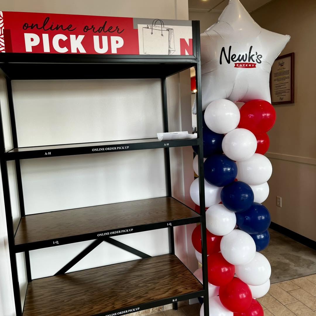 Red, white and navy balloon column with a Newk's Eatery star balloon topper