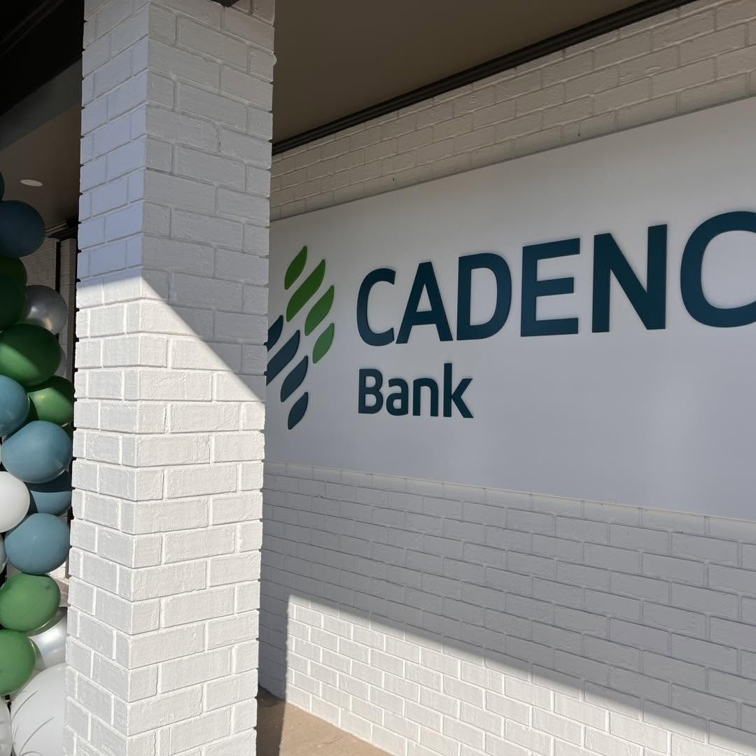 Cadence Bank branded wall signage with balloon garland accents