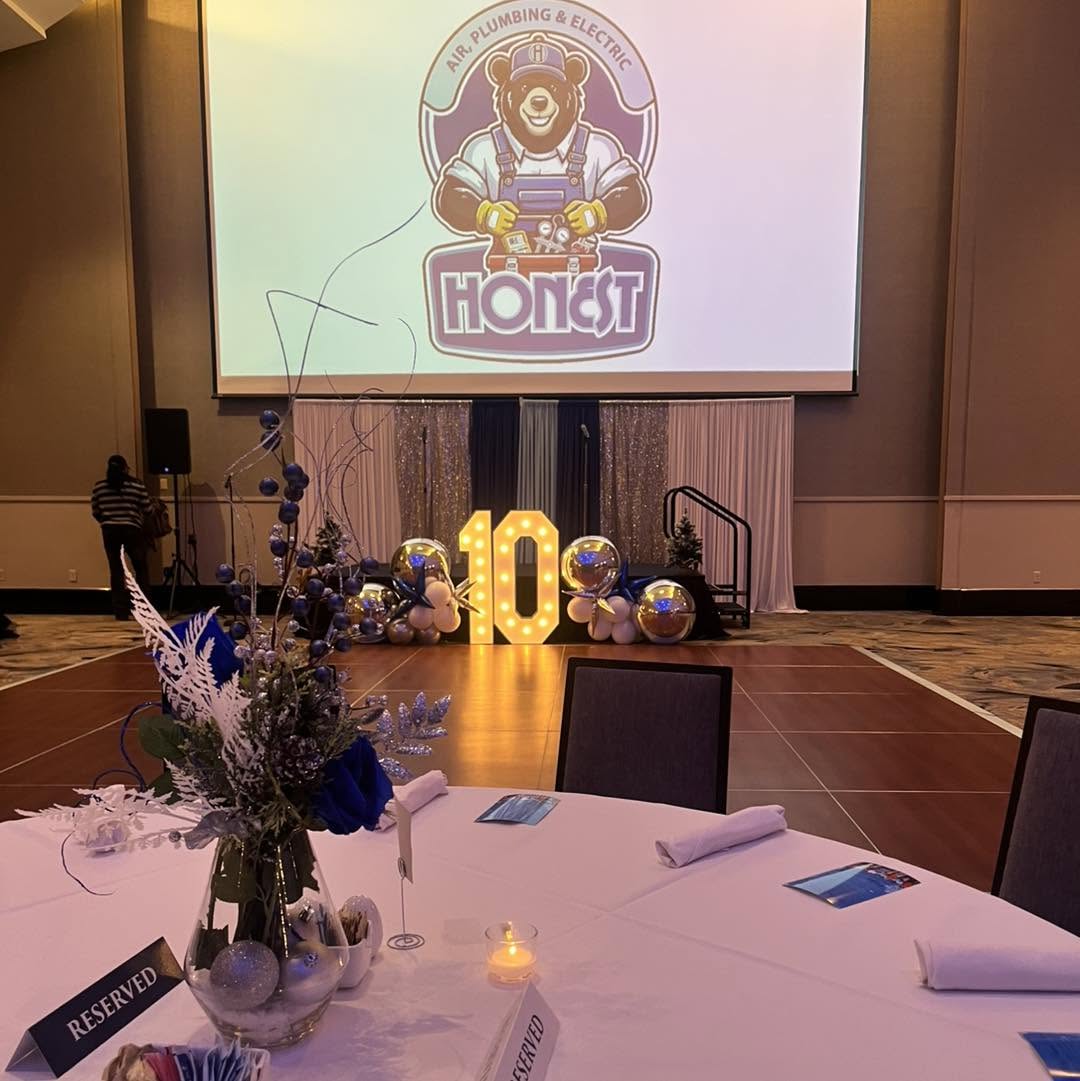 Honest Air anniversary gala tablescape with marquee 10 and balloon stage décor
