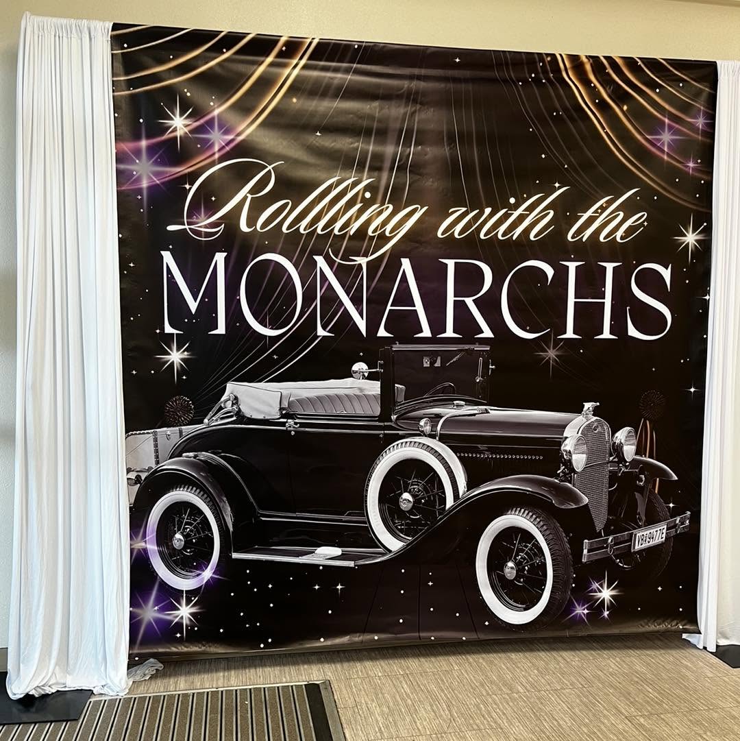 Printed vinyl backdrop with custom artwork framed by draping