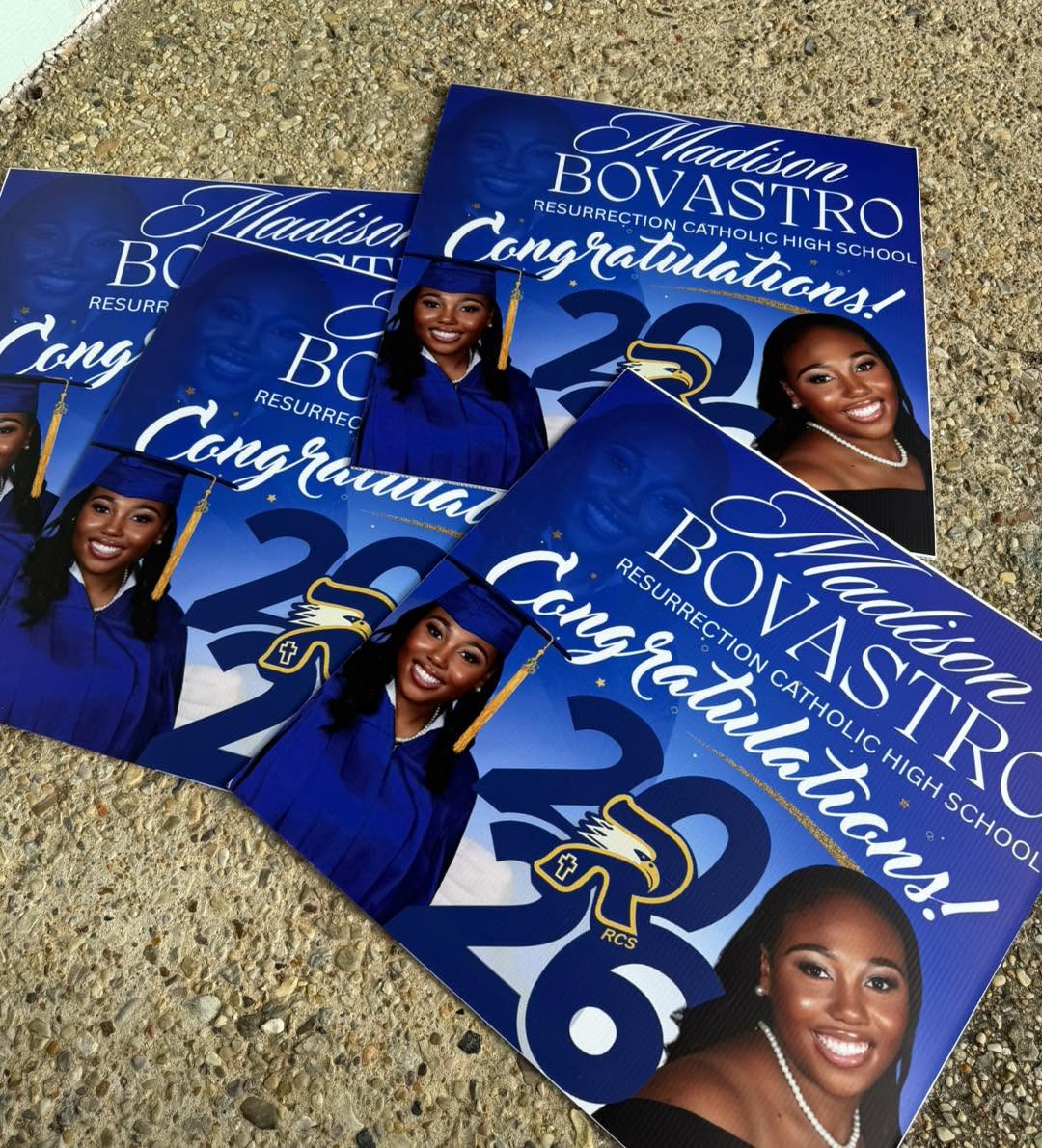 Stack of printed blue graduation congratulations yard signs