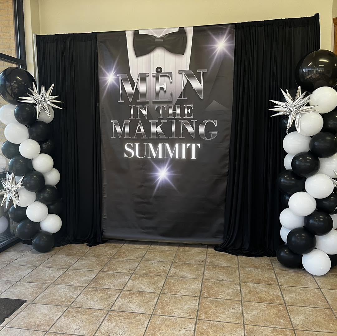 Printed event poster displayed between draping panels