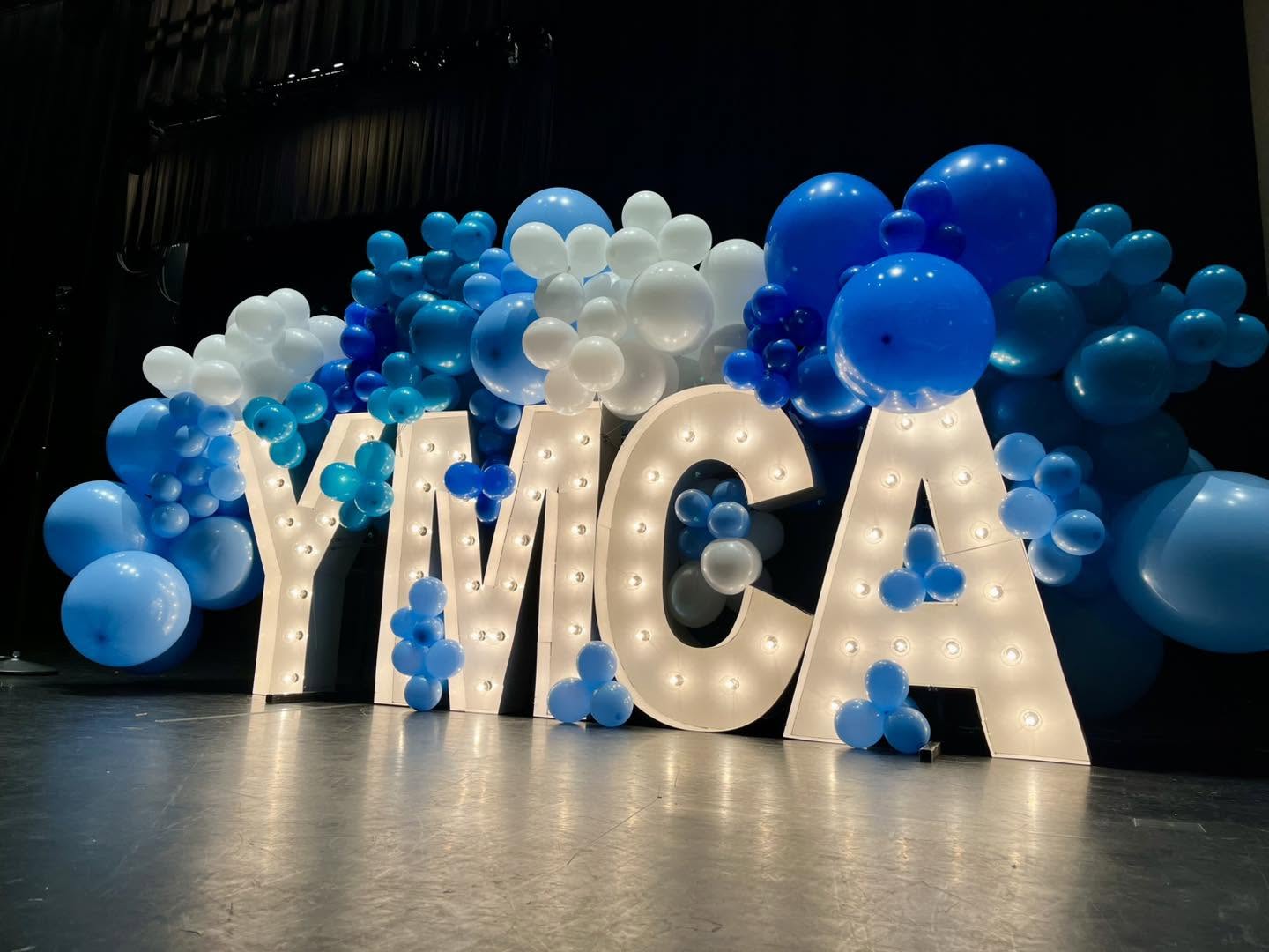 YMCA marquee letters with blue balloon installation
