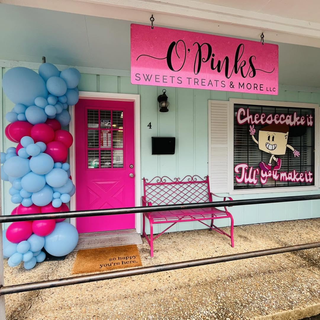Pink and blue balloon column beside the O'Pinks Sweets Treats storefront door